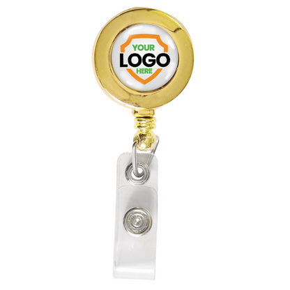 Circular custom badge reel with a gold rim features a customizable "Your Logo Here" center and a retractable clear plastic strap ending in a metal snap for attachment, perfect for enhancing brand awareness. Silver or Gold Custom Printed Retractable Badge Reels With Belt Clip - Upload Your Logo.