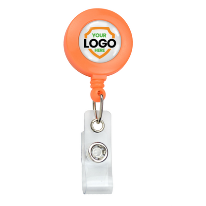 A Neon Custom Badge Reel With Belt Clip (P/N 2120-308X) - Add Your Logo with an orange circular casing and clear plastic clip, featuring a blank space for inserting a brand logo. Sold by Specialist ID.