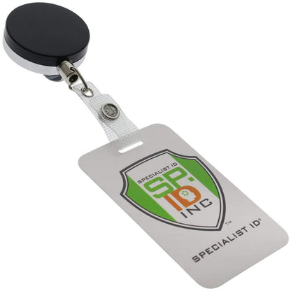 A Heavy Duty Badge Reel With Steel Cable 2120-3305 with a black circular clip and a clear plastic strap attached to a white ID card displaying the Specialist ID logo and name.