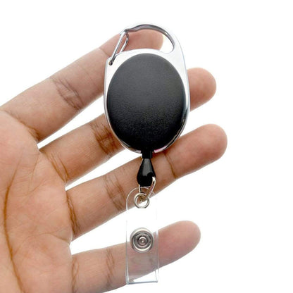 A person's hand holding a Carabiner Badge Reel - Premium Retractable Oval Badge Holder with Carabiner Clip for Belt Loops & Purse Straps (2120-70XX).