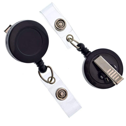 Two black Badge Reels with Swivel Spring Clips (P/N 2120-760X) with clear plastic strap holders lay on a white surface. Sold by Specialist ID.