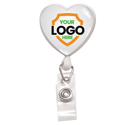 Custom Heart Shaped Badge Reel With Rotating Spring Clip - Personalize with Your Logo, featuring "YOUR LOGO HERE" inside a shield design. This custom badge reel promotes brand awareness with its clear snap clip attachment.