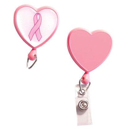Two pink Custom Heart Shaped Badge Reels with Rotating Spring Clip - Personalize with Your Logo add a touch of charm. One showcases a breast cancer awareness ribbon, while the other is plain. Each features a retractable cord and clip for attaching badges, perfect for those looking to promote brand awareness with custom badge reels.