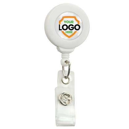 A Standard Custom Printed Badge Reels w/ No Twist Design - Add Your Logo to Personalize with a transparent clip and a round surface labeled "YOUR LOGO HERE" inside an orange and green shield, perfect for promoting brand awareness. This custom badge reel is an excellent way to enhance your professional image.