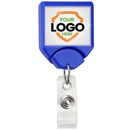 A blue, retractable Custom Printed B-REEL Retractable Badge Reel with Saw-Toothed Swivel-clip with a clip and a square front displaying a shield graphic with the text "YOUR LOGO HERE." This custom badge reel is perfect to promote brand awareness.