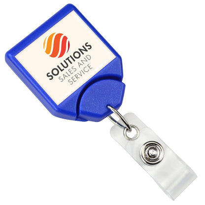 A **Personalized B-REEL Retractable Badge Reel with Belt Clip - Upload Your Logo** featuring a blue retractable holder with a white square front displaying the logo and text "Solutions Sales and Service," attached to a clear plastic clip, ideal for enhancing brand awareness.