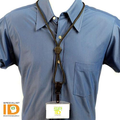 A person wearing a blue button-up shirt with a Heavy Duty Breakaway Round Lanyard With Detachable Bulldog Clip 2135-451X around their neck holding an ID badge. The bottom of the shirt pocket is visible. The ID badge has a logo with "SP" and the number "10". The lanyard features a breakaway feature for safety.