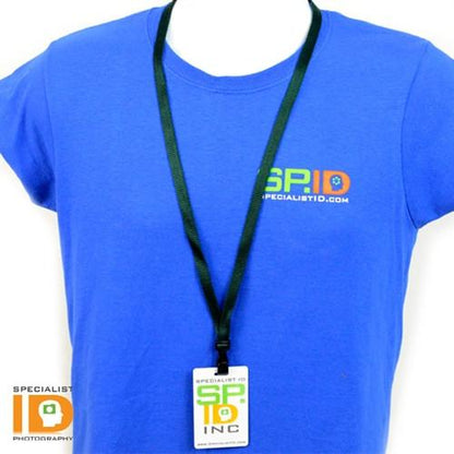 Person wearing a blue T-shirt with the "Specialist ID" logo, proudly showing off a black, Earth Friendly Bamboo Lanyard - Extra Soft - with Breakaway and Wide Plastic Hook 2137-204X holding a badge.