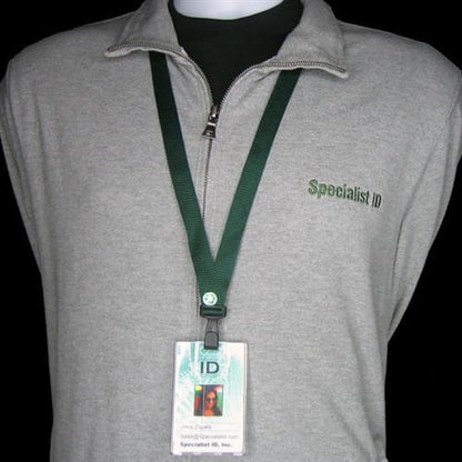 A person wearing a gray pullover with a zipper and a green lanyard with an ID badge hanging around their neck. The pullover has "Specialist ID" embroidered on it. To top it off, the Earth Friendly Breakaway Bamboo Wide Flat Lanyard (2137-205X) has a breakaway feature for added safety.