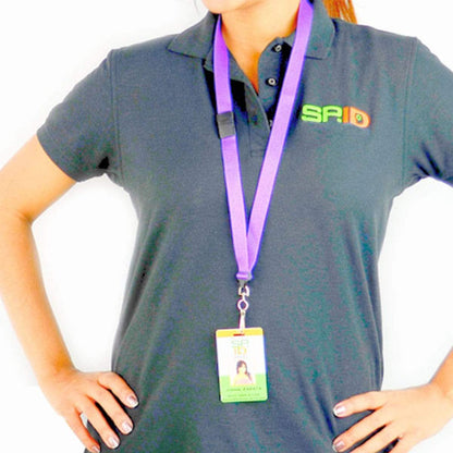 Person wearing a black polo shirt with a green logo and a Flat Wide Breakaway Lanyard with Swivel Hook - 5/8 Inch Width (2138-500X) holding an ID card around their neck, standing with hands on hips.