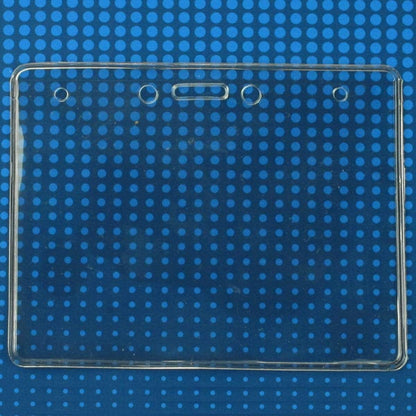 A clear Economical 4 x 3 Horizontal Badge Holder - Clear Vinyl 4x3 Card Holder with Lanyard Slot & Chain Holes with three punch holes at the top, perfect for ID name tags, set against a blue background with small circular patterns.