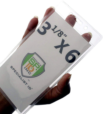 A hand holds a clear vinyl pouch with a white card inside. The card reads "3 1/8" X 6" and has a shield logo with "SPECIALIST ID" and "SP INC." text, perfect for cruise luggage tags or as a versatile badge holder like the 3X6 Vertical Badge Holder Clear Vinyl Credential Sleeve - Also Fits Cruise Luggage Tags (306-357).
