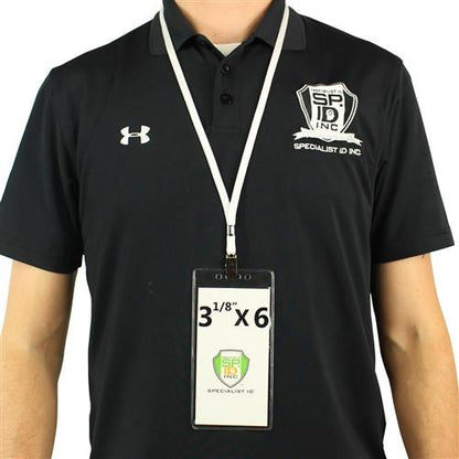 Person wearing a black polo shirt with a Specialist ID Inc logo, and a large ID badge in a 3X6 Vertical Badge Holder Clear Vinyl Credential Sleeve - Also Fits Cruise Luggage Tags (306-357) attached to a white lanyard around their neck.