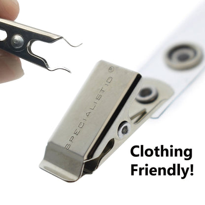 Close-up of a metallic badge clip labeled "SPECIALISTID" with a clothing-friendly loop and a hand holding a small metal tool nearby. Text on the image reads, "Clothing Friendly!" Featuring 5 Pack - Purple Heavy Duty Plastic Volunteer Badges with Clothing Friendly Clip.