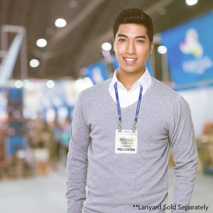 A man wearing a grey sweater and an event lanyard with a badge labeled "Presenter" stands in a convention or expo setting. Text at the bottom right reads: "*4 x 4 Badge Holder - Clear, Oversized ID Card Holder - Large Vinyl Event Badge Holder (1840-1612) Sold Separately".
