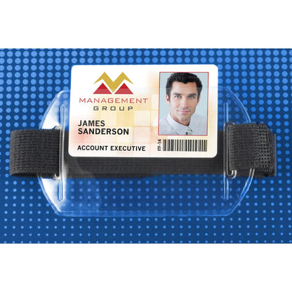 A photo ID badge labeled "James Sanderson, Account Executive" from Management Group, featuring a headshot and barcode, is held in a Heavy Duty Horizontal Armband Badge Holder with Elastic Hook & Loop Strap (504-AR1X) against a blue dotted background.
