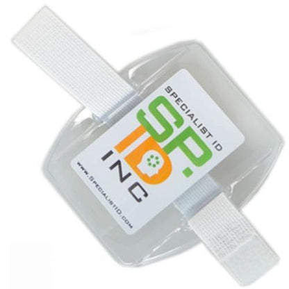 A gray and white Government ID Size Vertical Arm Band Badge Holder with Heavy Duty Vinyl and Hook & Loop Elastic Band (504-ARFB & 504-ARFW) with the text "SPECIALIST ID SP ID INC." and a web address, featuring adjustable Velcro straps.