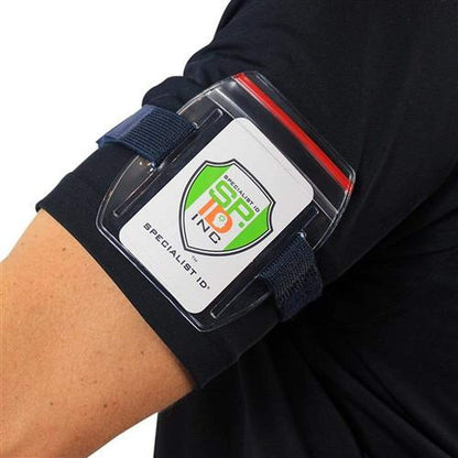 Close-up of a person wearing Vertical Armband ID Badge Holders with Zipper Top (504-ARZB & 504-ARZW) on their left arm. The holder, featuring a clear plastic cover with a Specialist ID logo card visible through it, ensures your photo ID card is secure and easily accessible.