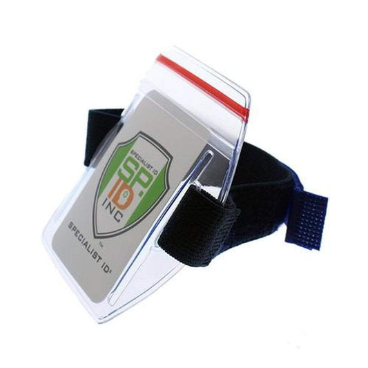 A clear plastic ID badge holder with a black adjustable strap, featuring a green and white logo ID card inside. This Vertical Armband ID Badge Holders with Zipper Top (504-ARZB & 504-ARZW) is designed for quick access and convenience.