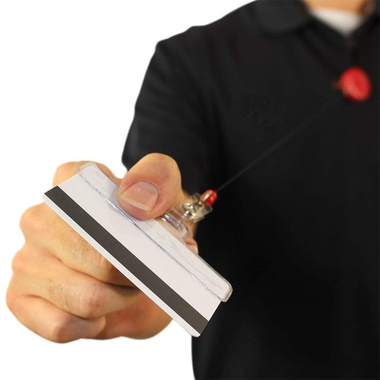 Person in a black shirt extending a white identification card with a black stripe on it, attached to a Horizontal Half Card Vinyl Holder with Slot (P/N 504-HC2).