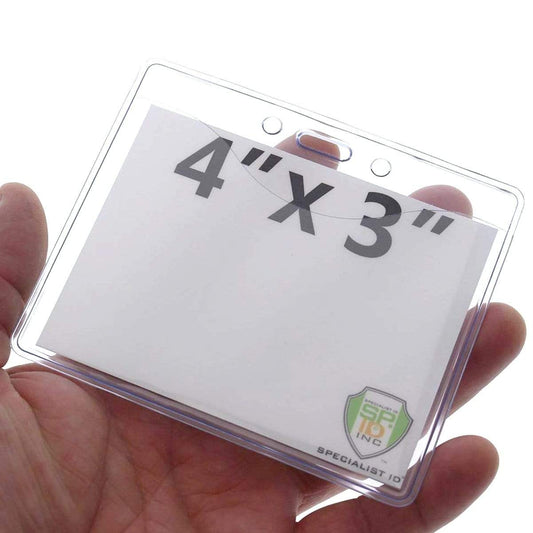 A hand holding a 4 X 3 Name Badge Holders - Premium Horizontal Clear Vinyl Convention Size 4x3 Badge Holder (506-J) with the dimensions "4'' x 3''" printed on a white insert inside.
