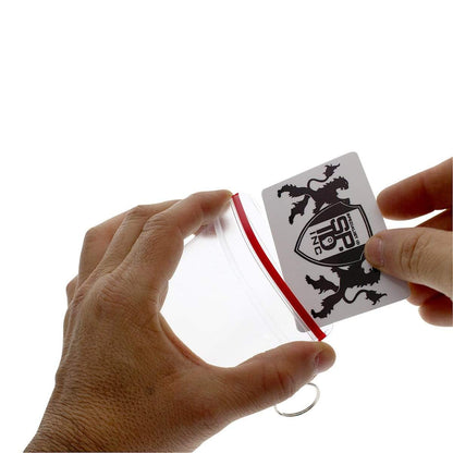 Two hands carefully place a card with a coat of arms into a Clear Soft Horizontal Fuel Card or ID Badge Holder w/ Zipper Closure & Key Ring 506-ZHKR.