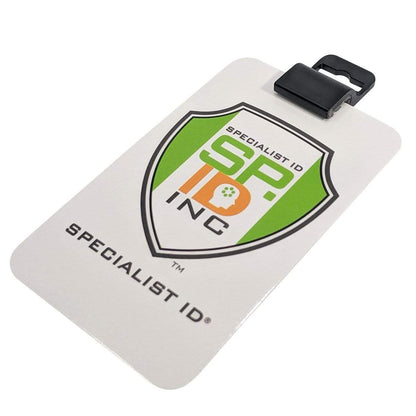 A white badge labeled "SPECIALIST ID INC" features the Specialist ID logo in green, orange, and white. The Gripper 30 Card Clamp (P/N 5710-3050 Black & 5710-3058 White) is attached to a black clip and fits perfectly into any standard ID card holder.