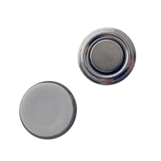 Two round, silver-colored snap buttons; one shows the front side with a smooth surface, while the other reveals a protruding mechanism for snapping. Ideal components for crafting a Magnetic Badge Finding, 1 Zinc-Plated Steel Encased Disc (P/N 5730-3030) or integrating into a magnetic badge holder.