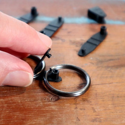HR-BLACK black plastic connector parts being assembled around a metal split ring