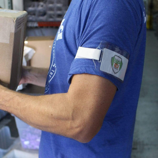 A person wearing a blue shirt with an adjustable Horizontal Arm ID Badge Holders (ABH-H) is carrying a cardboard box. Sold by Specialist ID.
