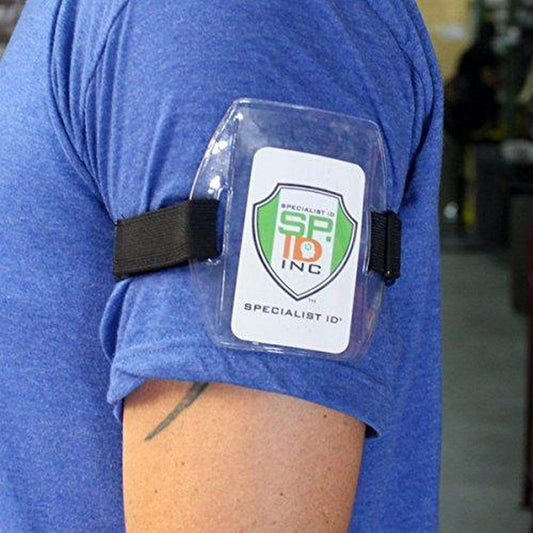 A person wearing a blue shirt and a black Vertical Armband ID Badge Holders with Elastic Band and Hook and Loop Clasp (ABH-V) displaying an ID card with the text "SPECIALIST ID INC.