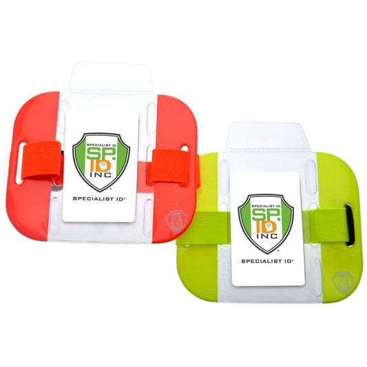 Two High Visibility Bright Neon Armband ID Card Badge Holders (AC-025) with wrist straps are shown. One is red with a white and green badge, and the other is yellow with a white and green badge, both featuring the "Specialist ID" logo. These high visibility armband-style holders are perfect for outdoor safety use.
