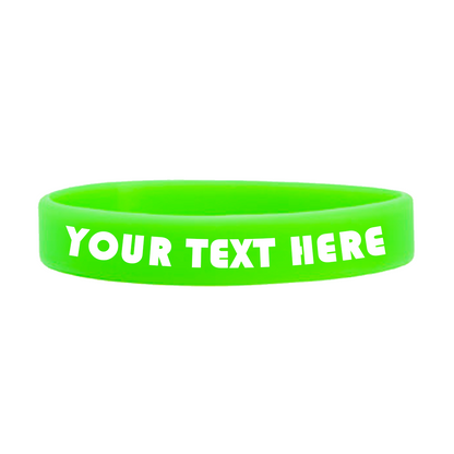 A high-quality green Customizable Adult 1/2" Silicone Wristband with the text "YOUR TEXT HERE" in white capital letters, perfect for promoting a cause. Customizable wristbands like this let you spread your message in style.