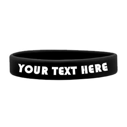 A black, high-quality Customizable Adult 1/2" Silicone Wristbands featuring "YOUR TEXT HERE" in bold white letters are perfect for promoting a cause. These customizable silicone wristbands allow you to personalize the message to suit your needs.