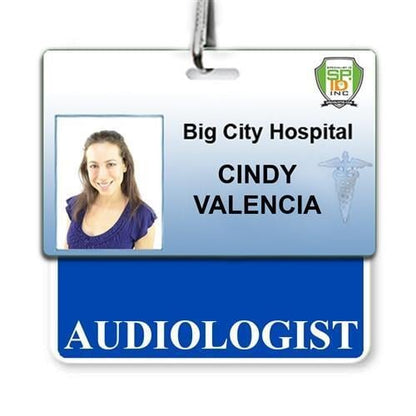 ID badge for Big City Hospital showing the name Cindy Valencia with the title "Audiologist" and a photograph of the badge holder, featuring an "AUDIOLOGIST" Horizontal Badge Buddy with Blue border for instant role recognition.