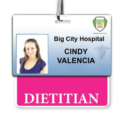 An ID badge for Big City Hospital with the name Cindy Valencia and a photo. The DIETITIAN Badge Buddy with Hot Pink Border - Horizontal features an additional pink section labeled "DIETITIAN" for clear roll recognition.