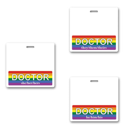 Three doctor name badges with a vibrant rainbow border celebrate diversity and inclusion. These gender pronoun badges prominently display "she/her/hers," "they/them/theirs," and "he/him/his" at the bottom, making them perfect DOCTOR Pronouns Badge Buddy Horizontal with Rainbow Border for any healthcare professional.
