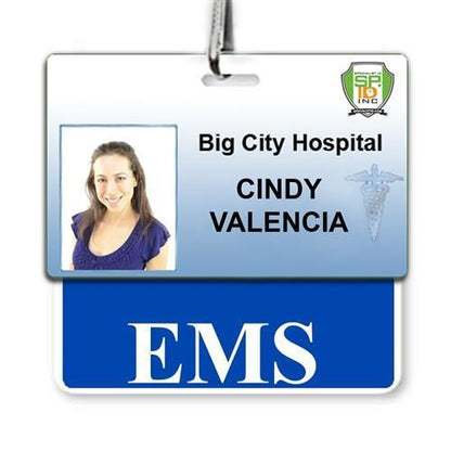 Employee badge for Big City Hospital in a bustling hospital setting. Featuring a photo of a woman, it identifies her as Cindy Valencia with an EMS Horizontal Badge Buddy with Blue Border clearly marked.