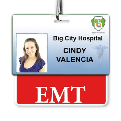 ID badge for Big City Hospital featuring a photo of Cindy Valencia. The hospital ID badge includes a green and yellow security seal and an EMT Emergency Medical Technician, Horizontal Badge Buddy with Red Border to highlight her role among paramedics.