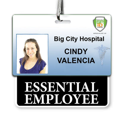 ID badge for Big City Hospital with a photo of Cindy Valencia. The badge includes her name and a caduceus symbol. Below, an attached tag reads "ESSENTIAL EMPLOYEE," offering instant role recognition. This ESSENTIAL EMPLOYEE Horizontal Badge Buddy with BLACK Border makes it clear she's an essential member of the team.
