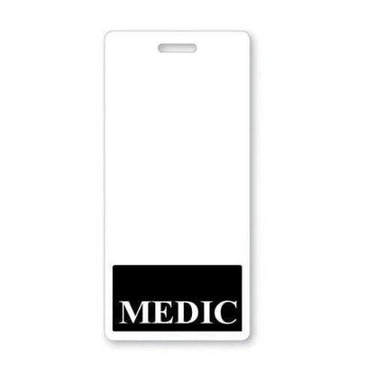 A white, vertical paramedic badge with a black section at the bottom featuring "MEDIC" in bold, white letters ensures instant role recognition can be achieved with the MEDIC Vertical Badge Buddy with BLACK Border.