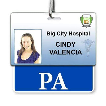 An ID badge for Big City Hospital features Cindy Valencia's photo on the left, her name in the center, and "PA Horizontal Badge Buddy with Blue Border" at the bottom, ensuring role recognition within the hospital environment.
