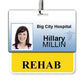 An ID badge with a photo of a woman, labeled "Big City Hospital," and the name "Hillary Millin." Below, a yellow tag with the word "REHAB" is attached as a REHAB Horizontal Badge Buddy with Yellow Border. The slot punched ID badge suggests it's meant for quick, easy access in a busy hospital setting.
