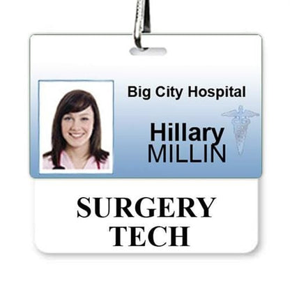 A hospital ID badge with a photo of a woman. The badge reads "Big City Hospital," "Hillary Millin," and "Surgery Tech" with a medical symbol, featuring an attached White SURGERY TECH Horizontal Badge Buddy to clearly identify surgery technicians.