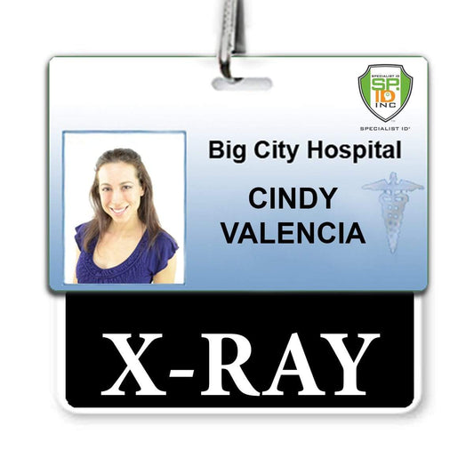 An X-RAY Horizontal Badge Buddy with BLACK Border for Big City Hospital features a photo of a woman and the name "Cindy Valencia" with the department "X-RAY" stated below. The hospital badge showcases Cindy's role clearly, ensuring quick identification in any situation.
