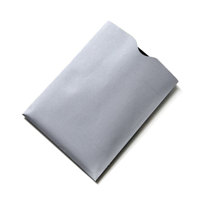 A grey, rectangular envelope with a folded flap, lying flat on a white surface, incorporates SkimSAFE Shielded RFID Passport Protection Sleeve 153036 (AH-225) for identity theft prevention.