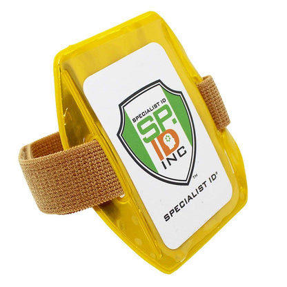 A yellow reflective armband features a clear plastic pocket displaying a white card with the logo "Vertical Reflective Armband ID Holder (R504-ARN)" and beige adjustable straps.