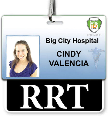 A hospital ID badge for Big City Hospital showing a picture of a smiling person named Cindy Valencia with an RRT title. A Specialist ID logo is in the top right corner. The badge includes an "RRT" Horizontal Badge Buddy for clear role recognition and is made from the highest quality synthetic paper.