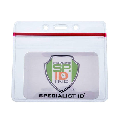 A Heavy Duty Clear Vinyl Horizontal Badge Holder With Resealable Zip Top (1815-1010) featuring a clear plastic cover and red zipper seam, containing an identification badge displaying the logo of "Specialist ID.