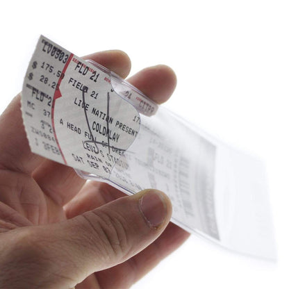 A person holding a Clear Ticket Holder for 2 1/8 X 5 5/8 Inch (Ticketmaster Size) Concert and Sporting Event Tickets & Credentials (SPID-1140) with a collectible concert ticket inside for a Coldplay event. The ticket shows details like seat number and price.
